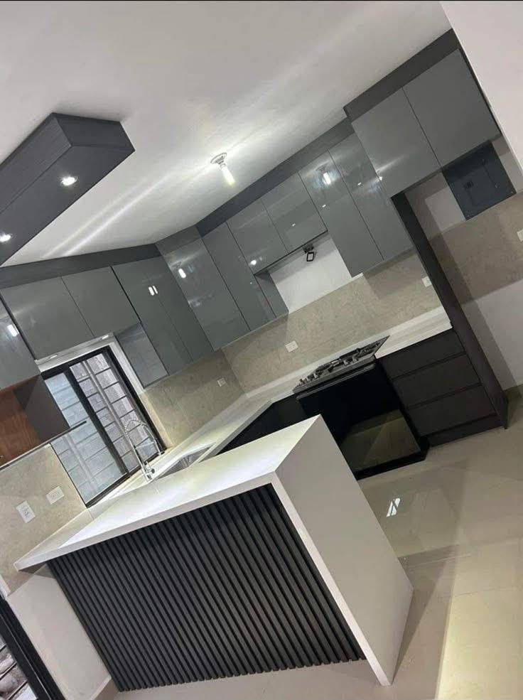 Gloss grey kitchen with angular island