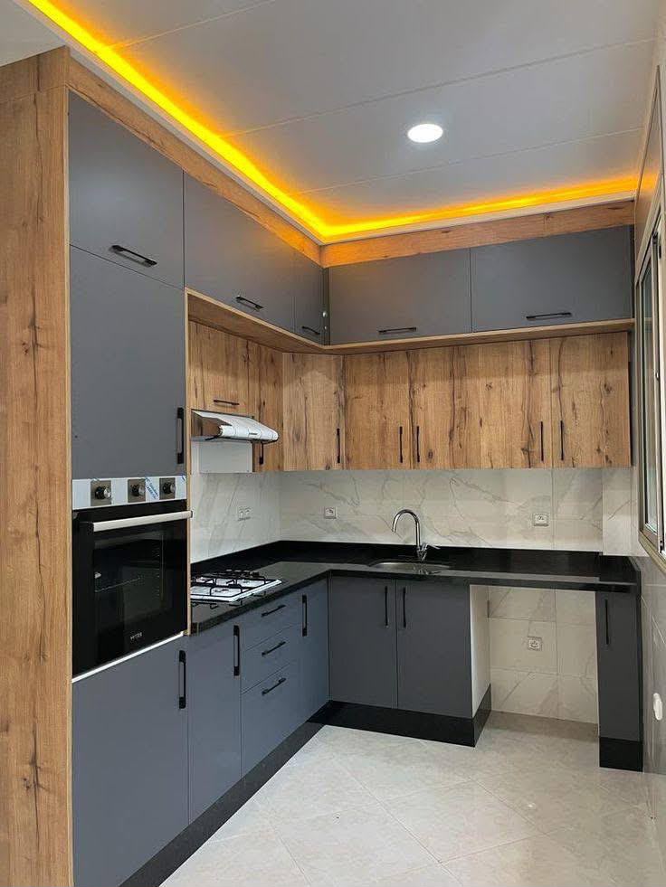 Grey and wood L-shape kitchen with LED cove lighting