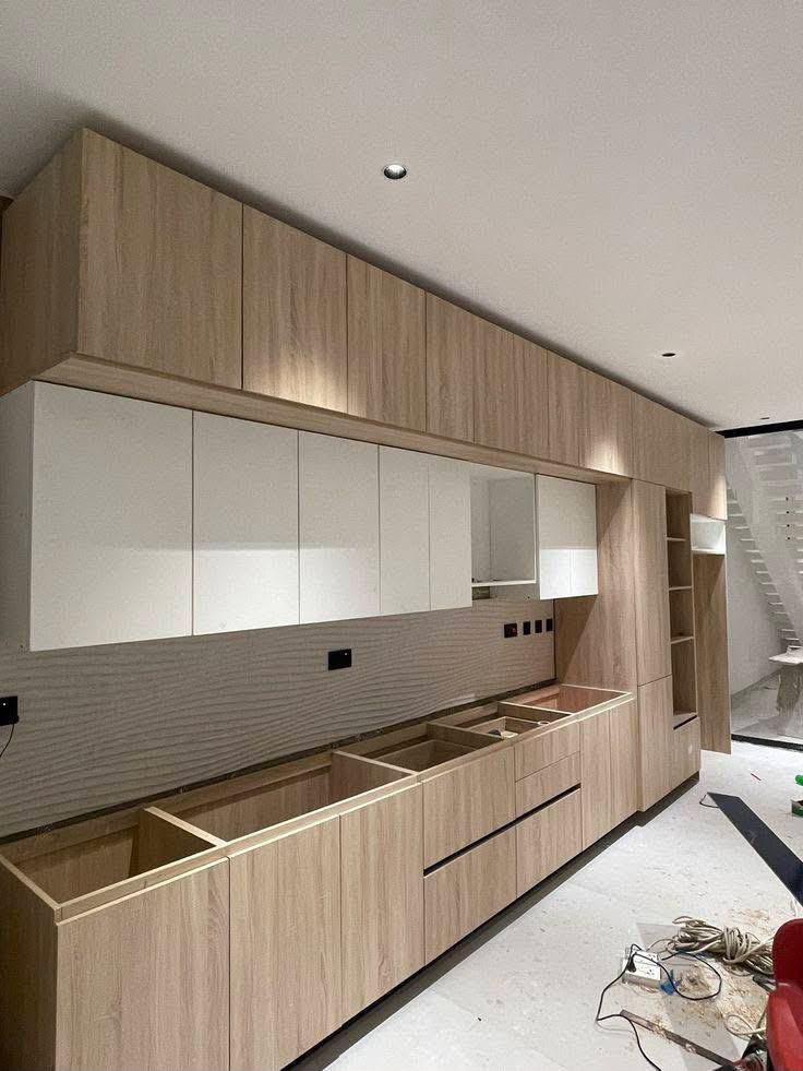 Light oak kitchen cabinetry in build
